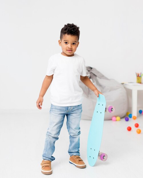 Front view of young boy with skateboard