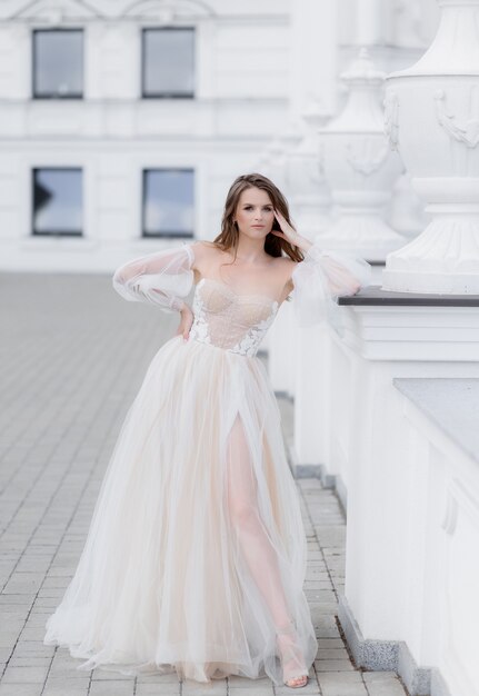 Front view of young bride stands and looks at the camera