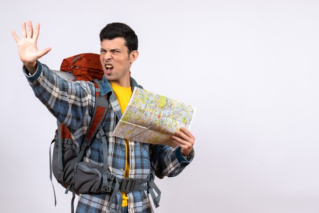 Front view young camper with backpack holding map making stop sign