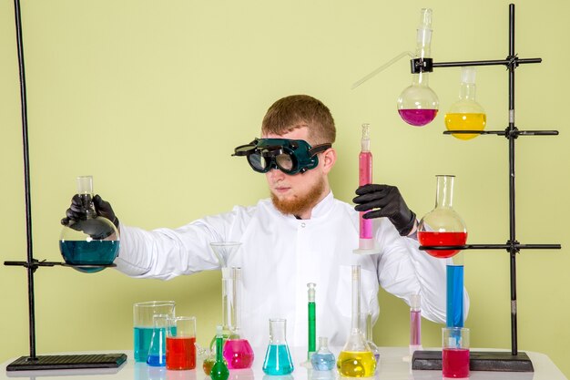 Front view young chemist creating new chemical mixed