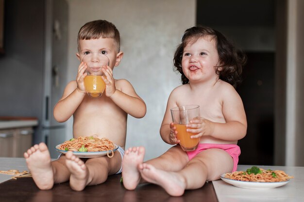 Front view young children serving food