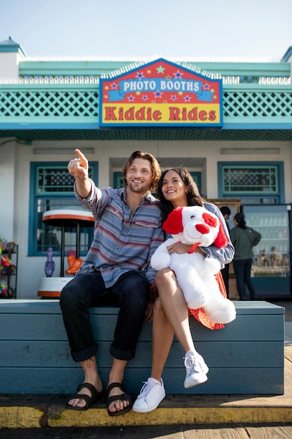 Front view of young couple on a date together and pointing at the horizon