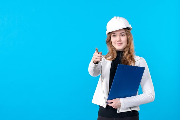 Front view young female architect in helmet