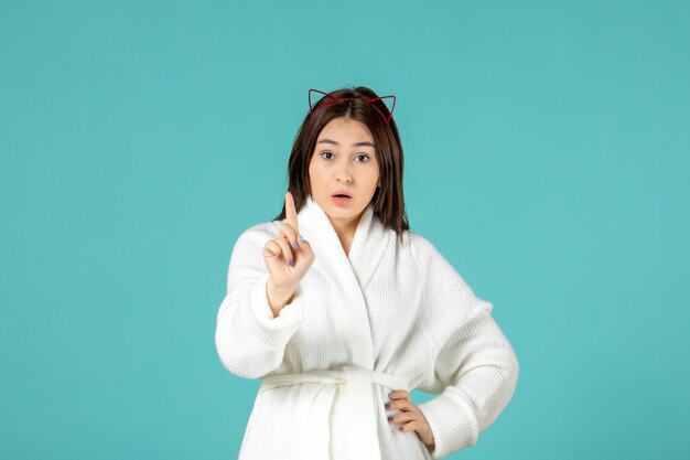 front view young female in bathrobe and different poses on blue background