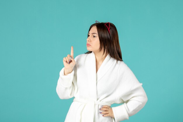 front view young female in bathrobe and different poses on blue background