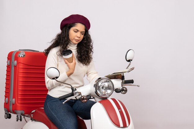 Front view young female on bike holding map and coffee on white background city color road vehicle motorcycle speed