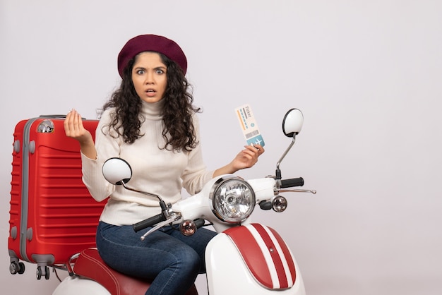 Front view young female on bike holding ticket on white background flight color motorcycle road vehicle city speed