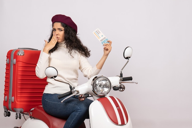 Front view young female on bike holding ticket on white background speed city vehicle vacation flight color road