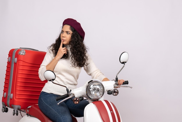 Front view young female on bike with her bag on white background color ride road speed motorcycle vacation vehicle