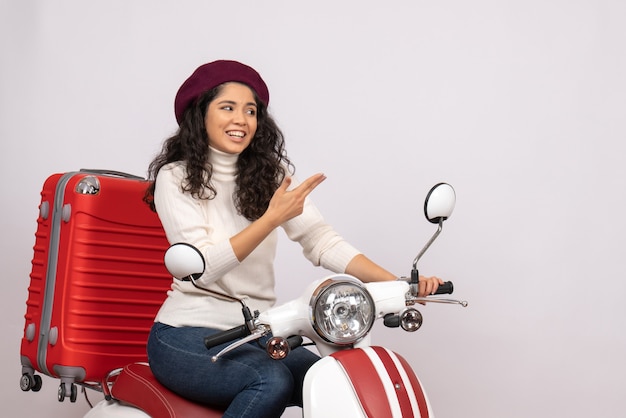 Front view young female on bike with her bag on white background color road speed vacation vehicle motorcycle ride