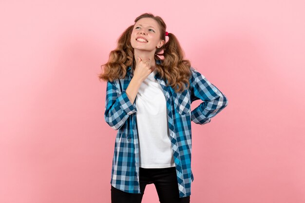 Front view young female in blue checkered shirt posing on light pink background girl youth emotion model fashion kid