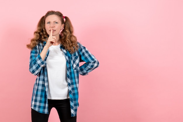 Front view young female in blue checkered shirt posing on light pink background youth emotion girl kid model fashion