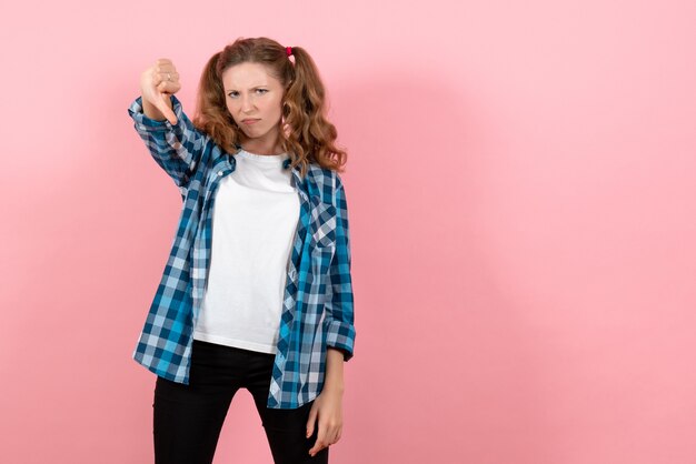 Front view young female in blue checkered shirt posing on pink background emotion girl fashion model youth kid