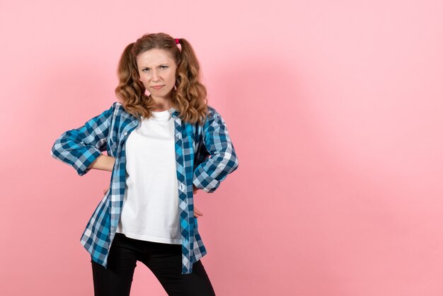 Front view young female in blue checkered shirt posing on pink background woman emotion girl fashion color model