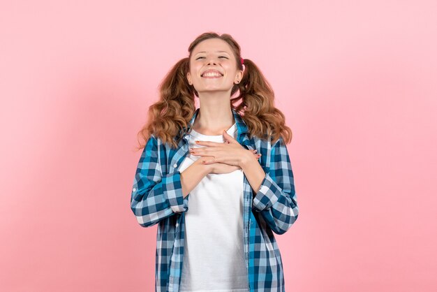 Front view young female in blue checkered shirt with happy expression on pink background woman emotions model fashion girls color