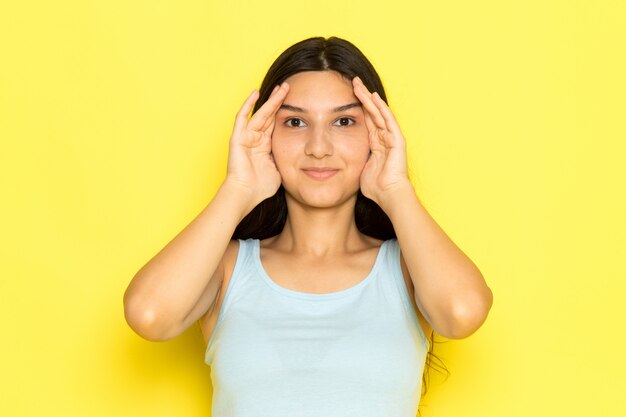 A front view young female in blue shirt posing with smile