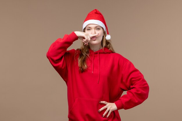 Front view young female on a brown background christmas emotion holiday