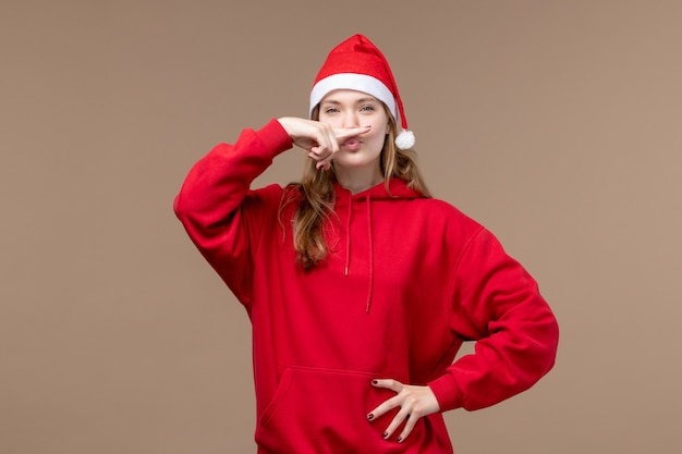 正面図茶色の背景の若い女性クリスマス感情休日
