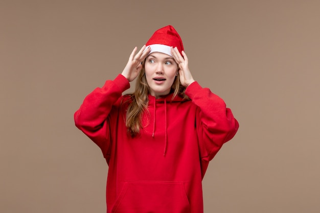 Front view young female on brown background christmas emotion holiday