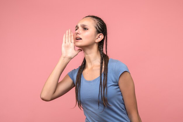 Front view of young female calling on pink