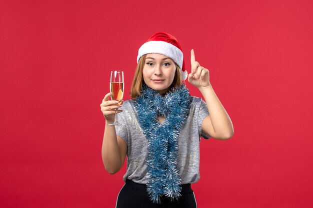 Front view young female celebrating new year on the red wall holiday color christmas