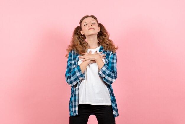 Front view young female in checkered shirt posing on pink background model woman emotions kid youth color