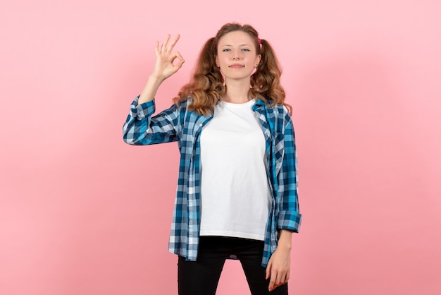 Front view young female in checkered shirt posing on pink background youth woman emotion model kid color