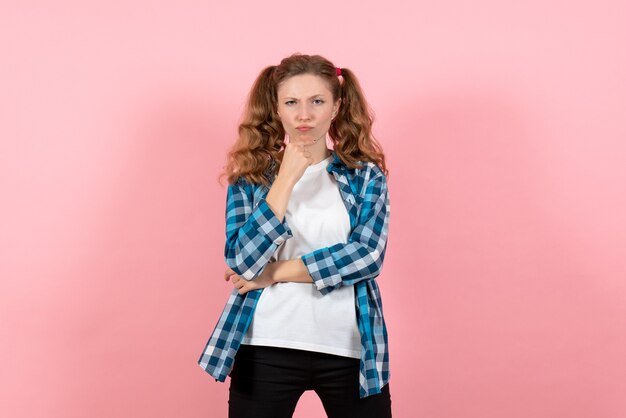 Front view young female in checkered shirt posing and thinking on pink background youth woman color emotions model kid