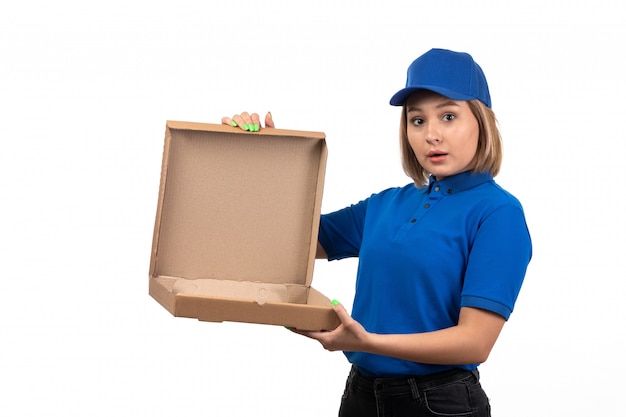 A front view young female courier in blue uniform holding food delivery package