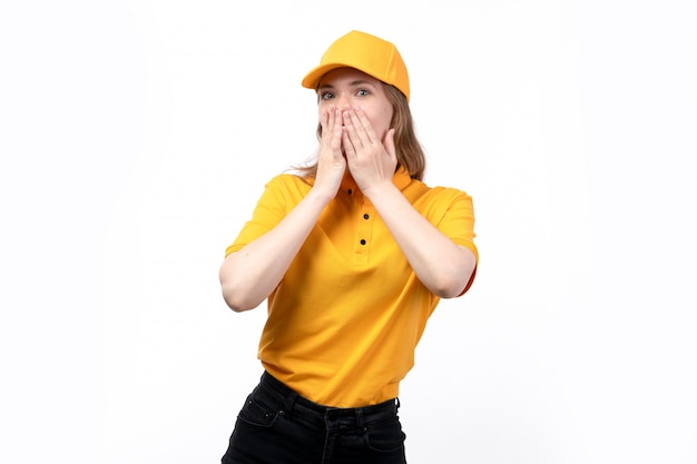 A front view young female courier female worker of food delivery service covering her mouth with excited expression on her face on white