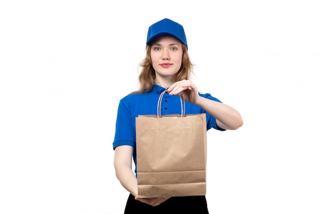 A front view young female courier female worker of food delivery service holding delivery package on white