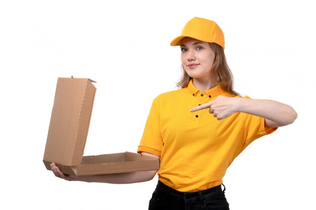 A front view young female courier female worker of food delivery service holding an empty pizza box on white