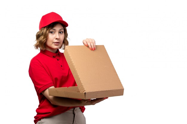 A front view young female courier female worker of food delivery service holding an empty pizza box on white