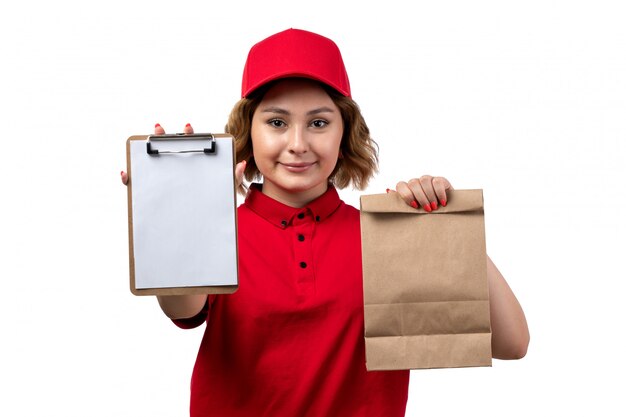 A front view young female courier female worker of food delivery service holding food package and notepad on white