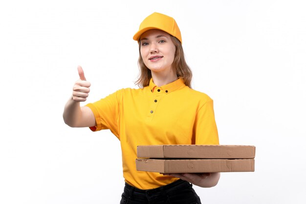 A front view young female courier female worker of food delivery service holding pizza boxes on white