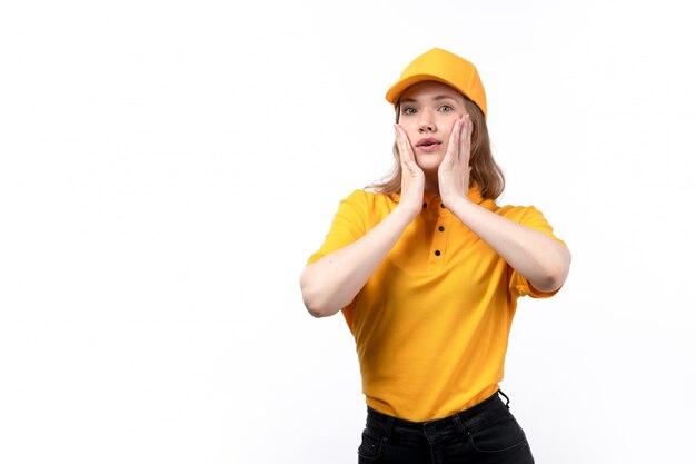 A front view young female courier female worker of food delivery service posing touching her face on white