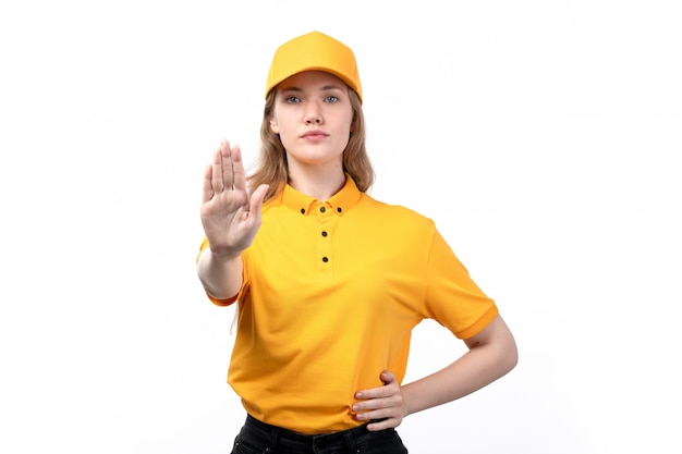 A front view young female courier female worker of food delivery service showing stop sign on white