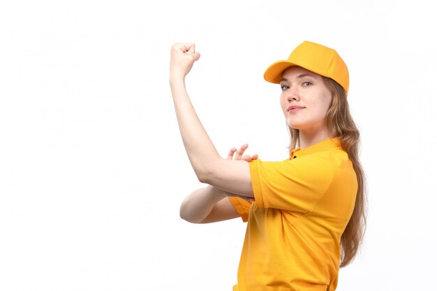 A front view young female courier female worker of food delivery service smiling and flexing on white