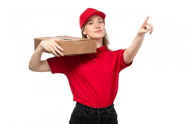 A front view young female courier female worker of food delivery service smiling holding delivery box on white