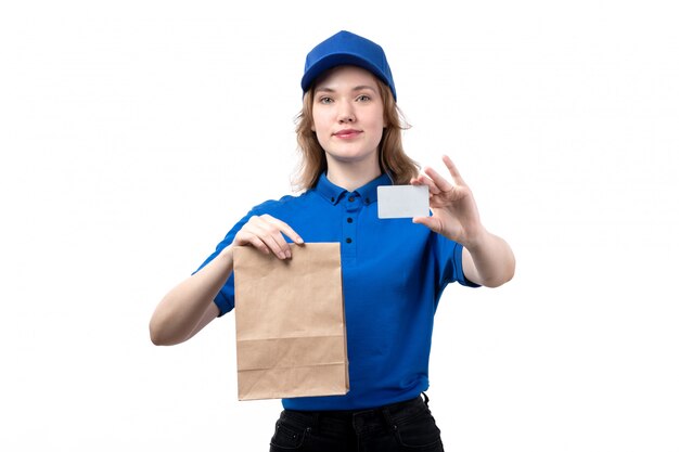 A front view young female courier female worker of food delivery service smiling holding food delivery package and white card on white