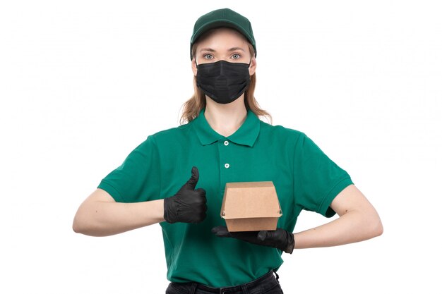 녹색 유니폼 검은 장갑과 음식 배달 패키지를 들고 검은 마스크에 전면보기 젊은 여성 택배