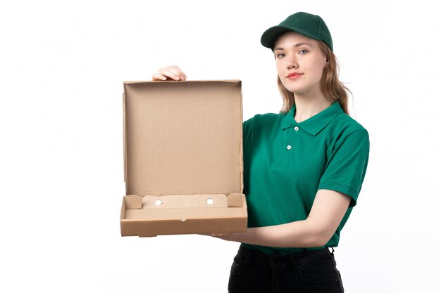 A front view young female courier in green uniform holding food delivery package