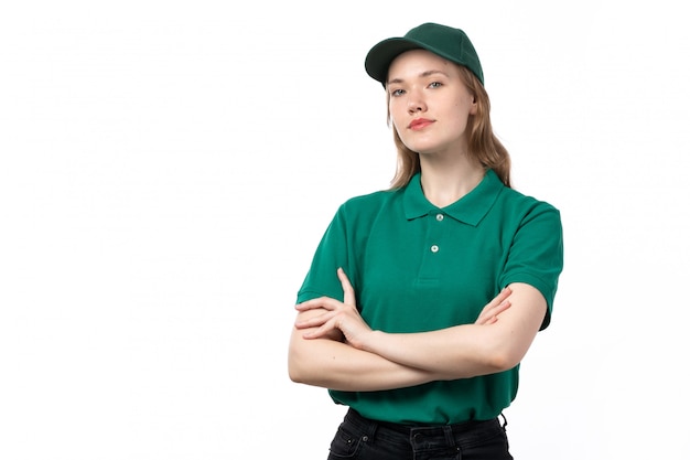 A front view young female courier in green uniform posing in calm condition