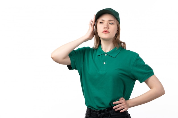 A front view young female courier in green uniform posing with confused expression
