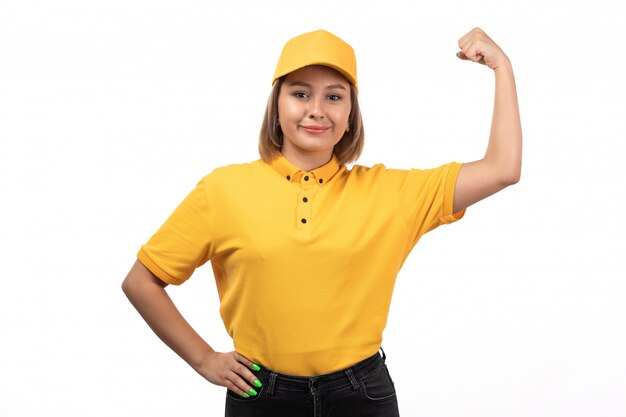 A front view young female courier in yellow uniform posing and flexing