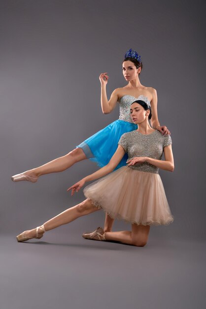 Front view of young female dancers posing in studio