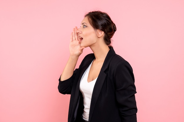 Front view young female in dark jacket calling someone on pink background