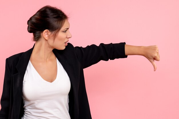 Front view young female in dark jacket displeased on pink background