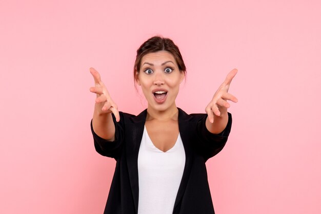 Front view young female in dark jacket excited on pink background