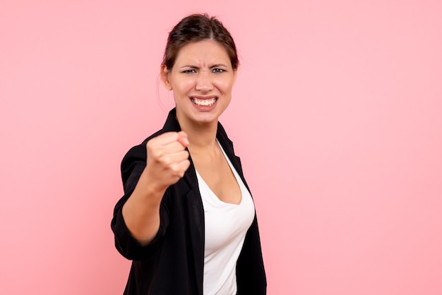 Front view young female in dark jacket on a pink background